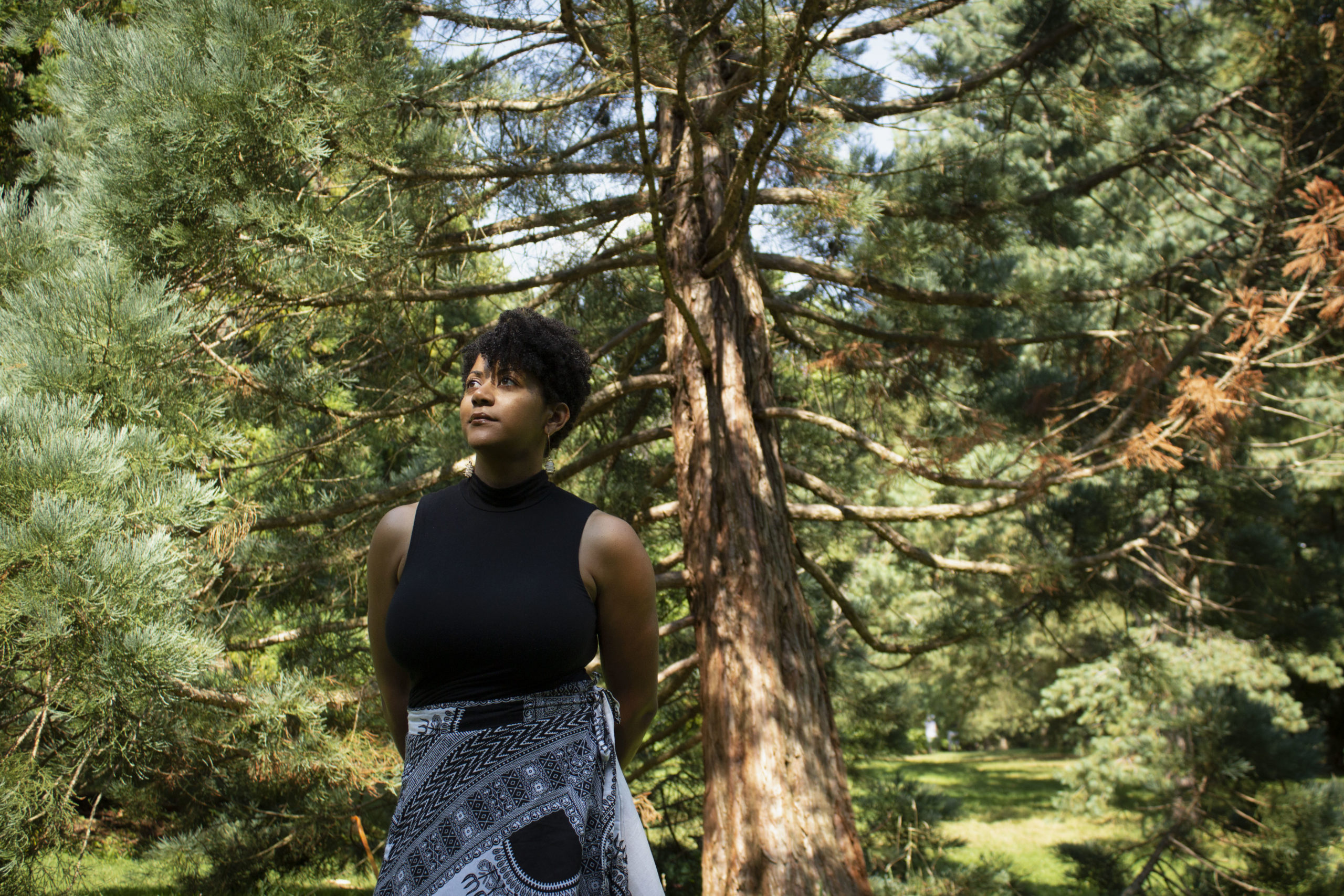 Ashleigh Gordon surrounded by trees.