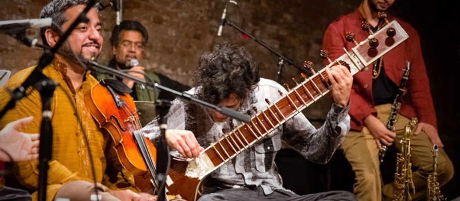 Musicians in the Brooklyn Raga Massive, including a violinist and a sitar player