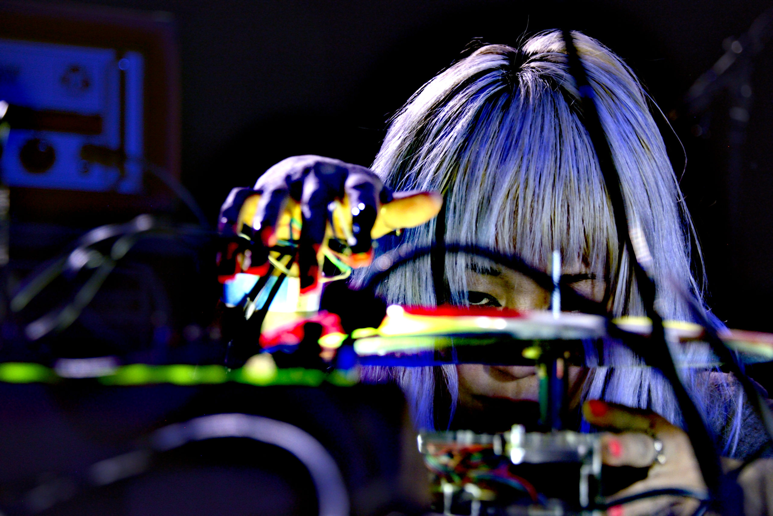 Victoria Shen carefully scratching a home made record with audio playback styluses affixed to her fingernails during a performance.