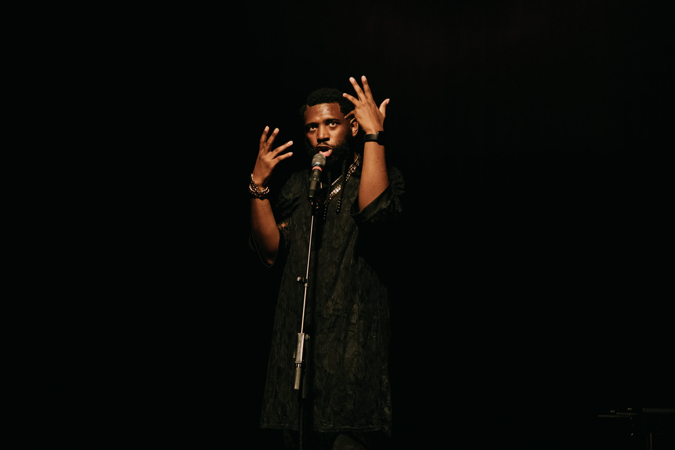 Jecorey Arthur standing in front of a microphone