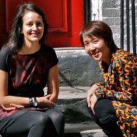 Two women sitting outdoors