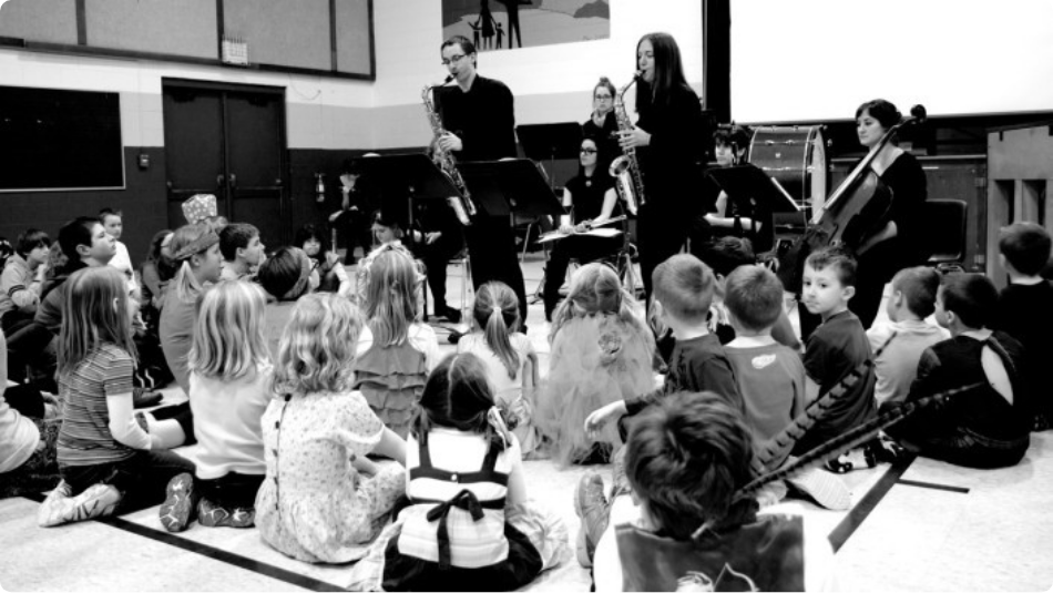 three musicians playing for little children